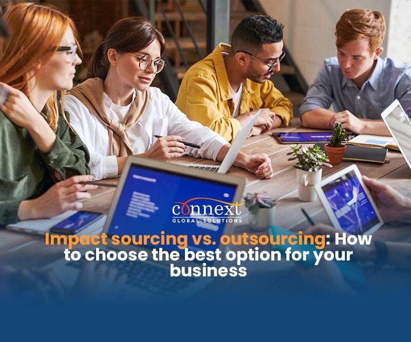 Impact-sourcing-vs.-outsourcing-choosing-the-right-option-for-your-business-men-and-women-in-corporate-attire-in-a-team-meeting-using-laptop-in-office-desktop-1@1x_1