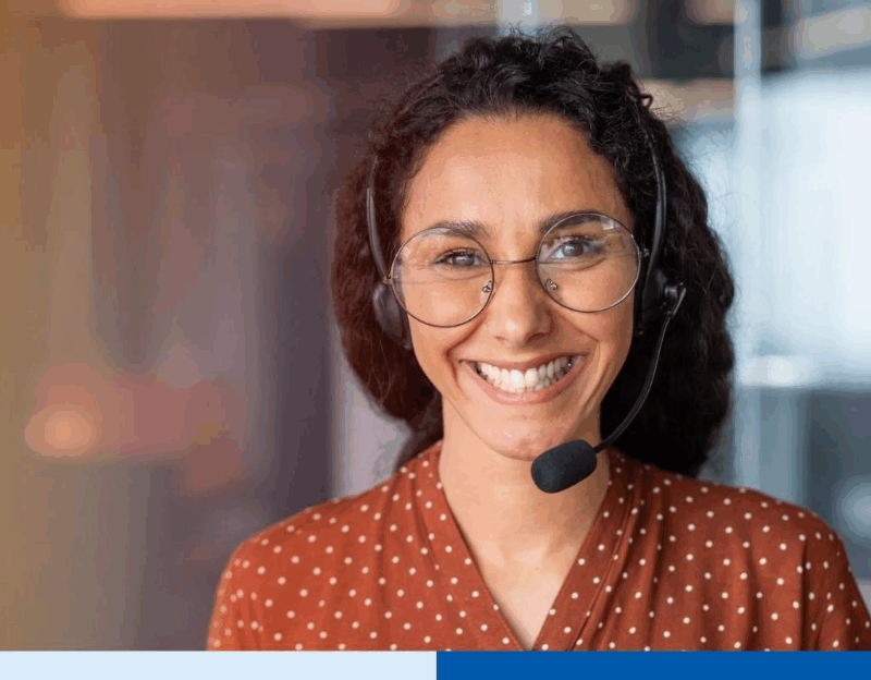 smiling latina woman wearing glasses and a headset, looking friendly and approachable