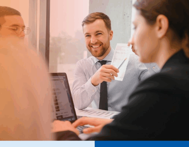man holding a receipt wearing corporate attire smiling in office in office setting meeting