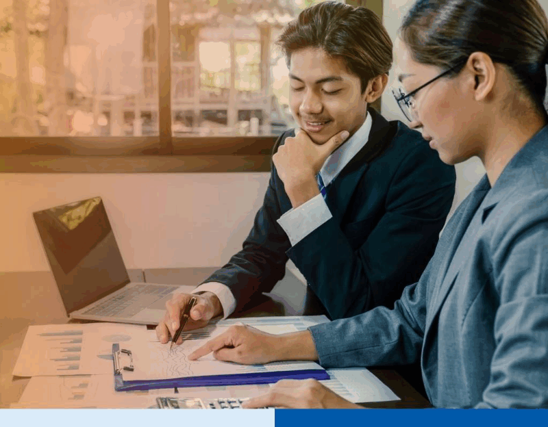 smiling people in corporate suit attire with paperwork and laptop in office