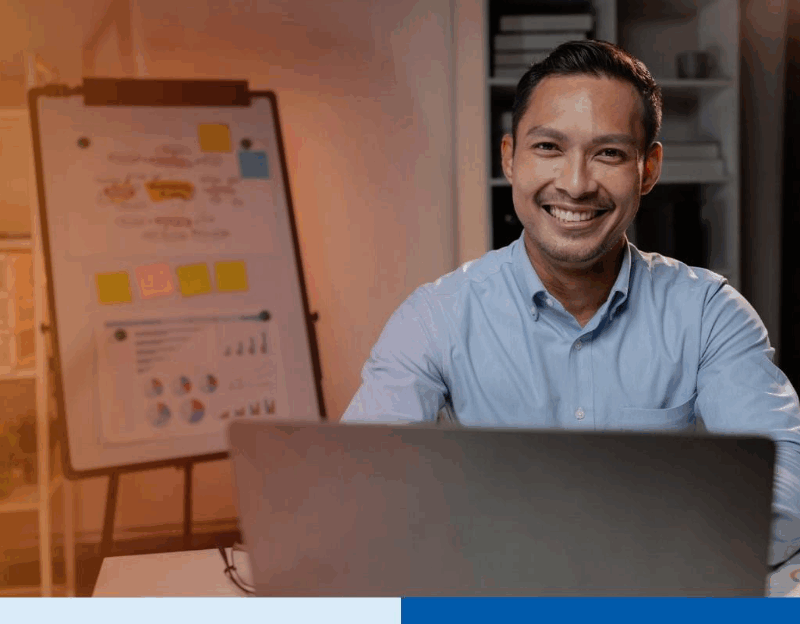 Asian businessman in startup office managing BPO vendor transition during hiring freeze in business process outsourcing