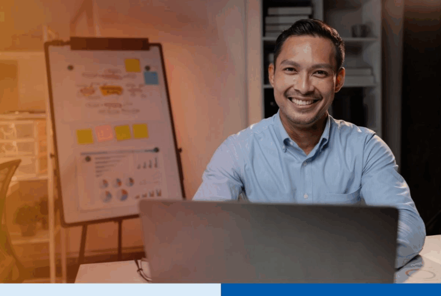 Asian businessman in startup office managing BPO vendor transition during hiring freeze in business process outsourcing