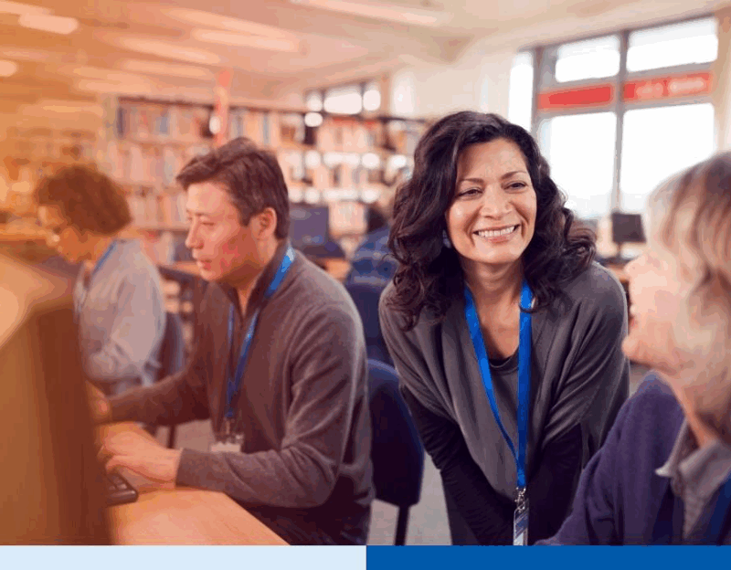 Business professionals working together in an office, illustrating employee rebadging and workforce flexibility during hiring freezes.